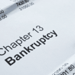 Close-up of Chapter 13 bankruptcy document with financial figures and pen