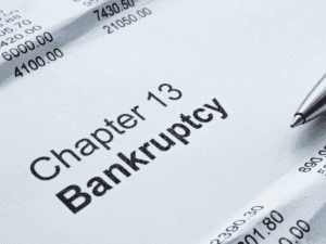 Close-up of Chapter 13 bankruptcy document with financial figures and pen